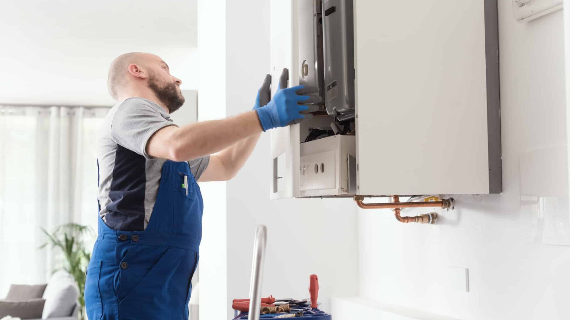 Professional engineer doing a boiler inspection at home